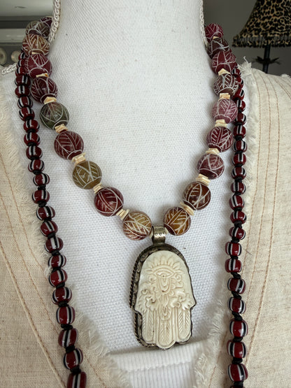 Carved red jade with carved bone hamsa short necklace.