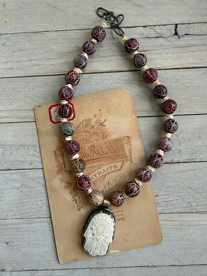 Carved red jade with carved bone hamsa short necklace.