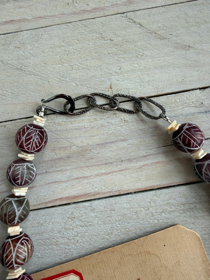 Carved red jade with carved bone hamsa short necklace.