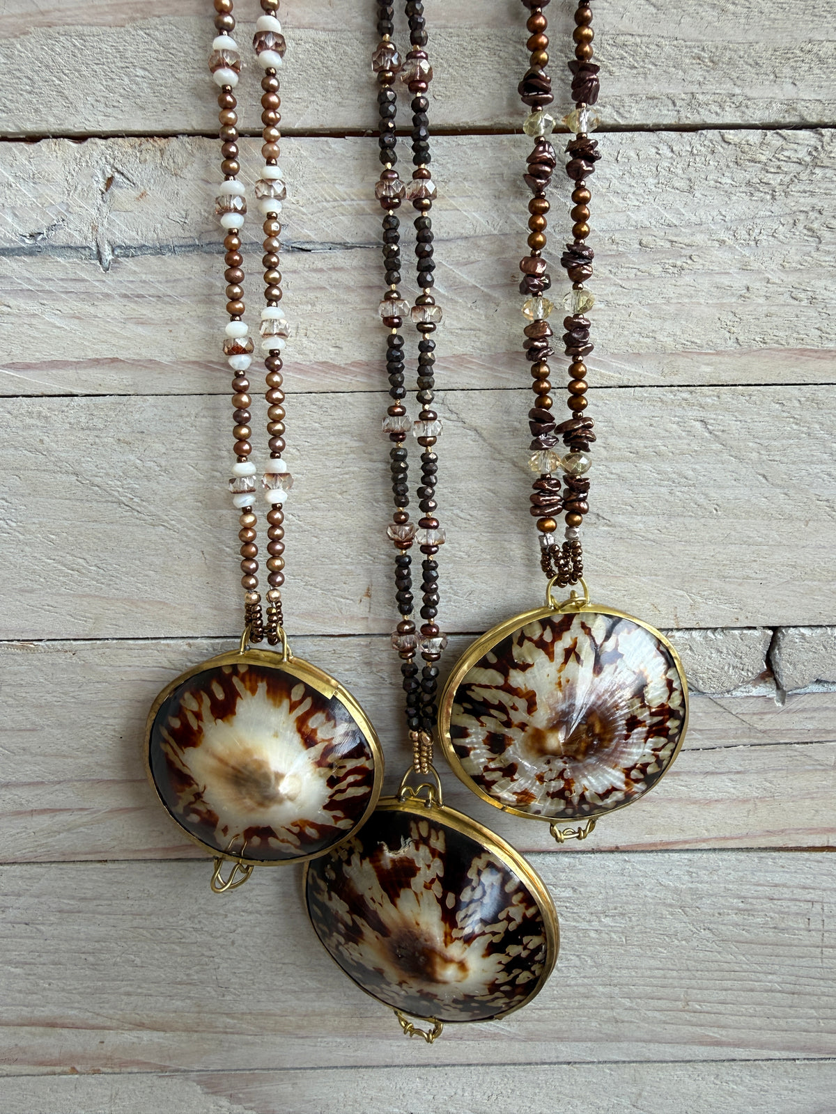 Limpet shell “purse” with chocolate pyrite, pearls, and Czech glass necklace. 