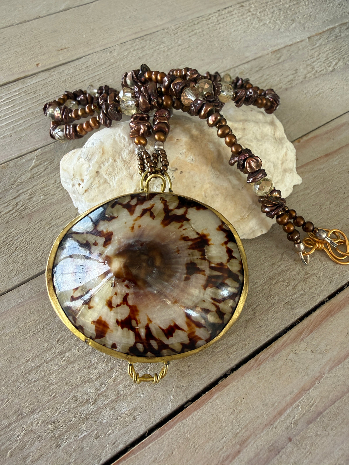 Shell “purse” on brown pearls and Czech glass necklace.