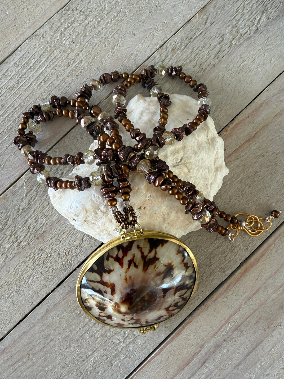 Shell “purse” on brown pearls and Czech glass necklace.