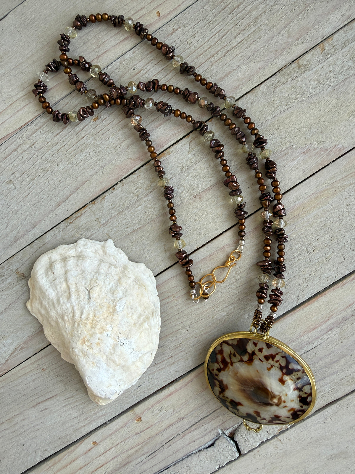 Shell “purse” on brown pearls and Czech glass necklace.