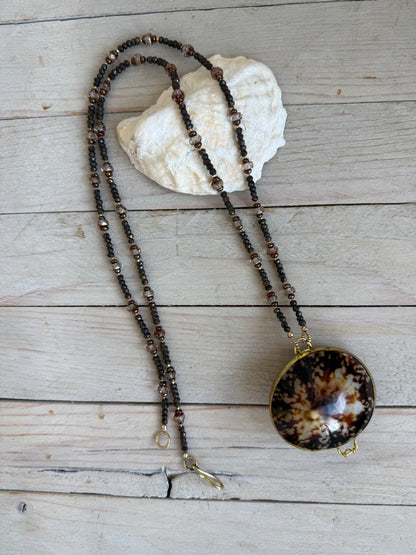 Limpet shell “purse” with chocolate pyrite, pearls, and Czech glass necklace. 