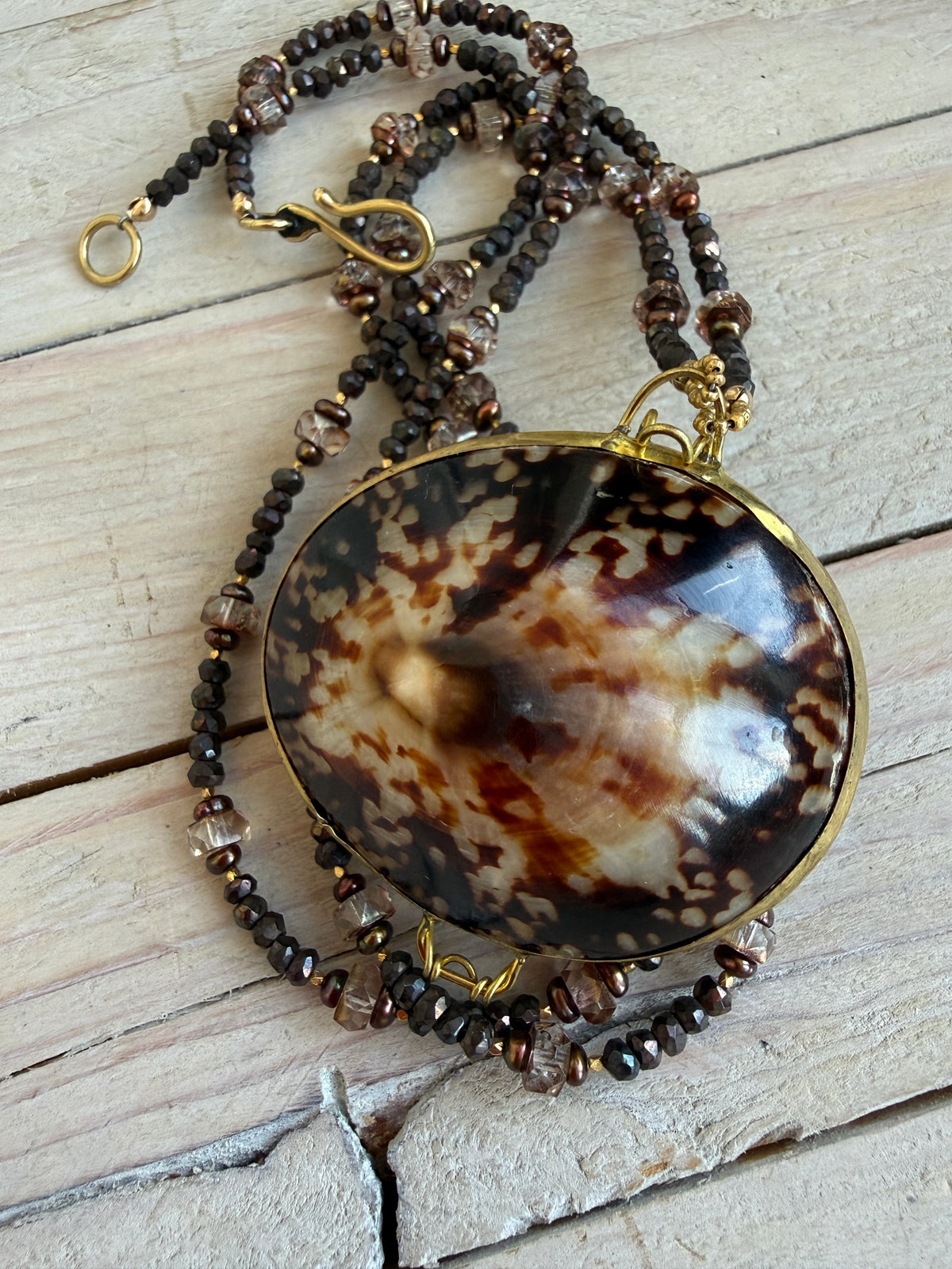 Limpet shell “purse” with chocolate pyrite, pearls, and Czech glass necklace. 