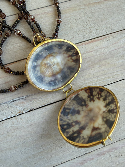 Limpet shell “purse” with chocolate pyrite, pearls, and Czech glass necklace. 
