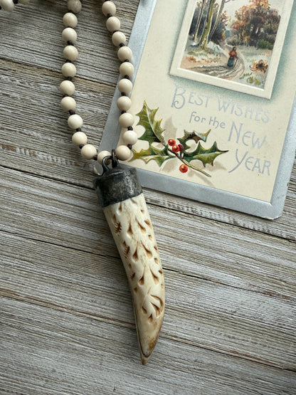 Carved bone on cream riverstone, smoky quartz accents long necklace. 36”