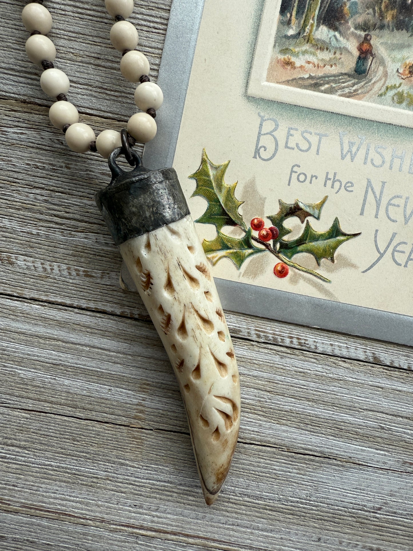 Carved bone on cream riverstone, smoky quartz accents long necklace. 36”