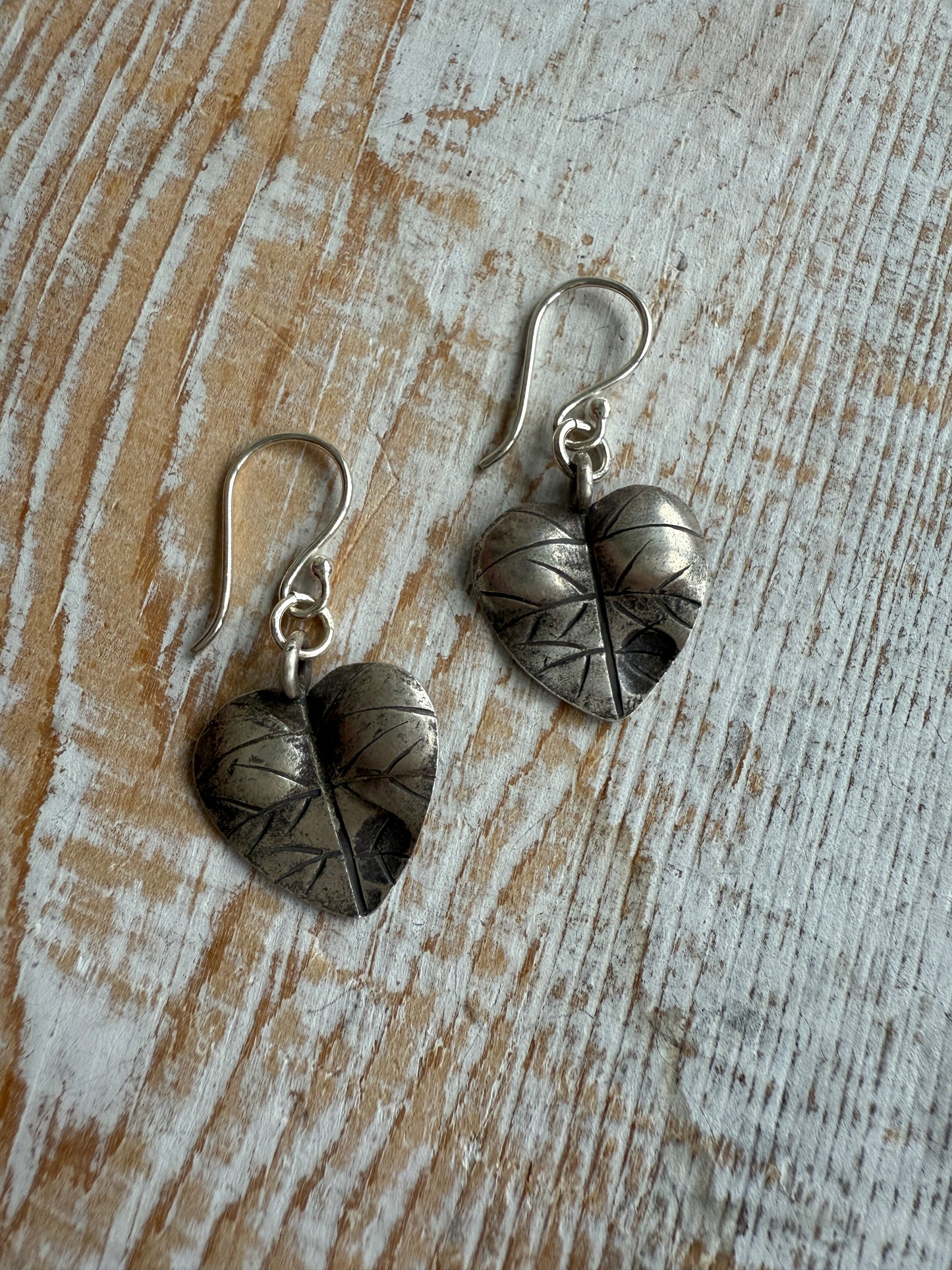 Heart shaped leaf earrings of fine silver.