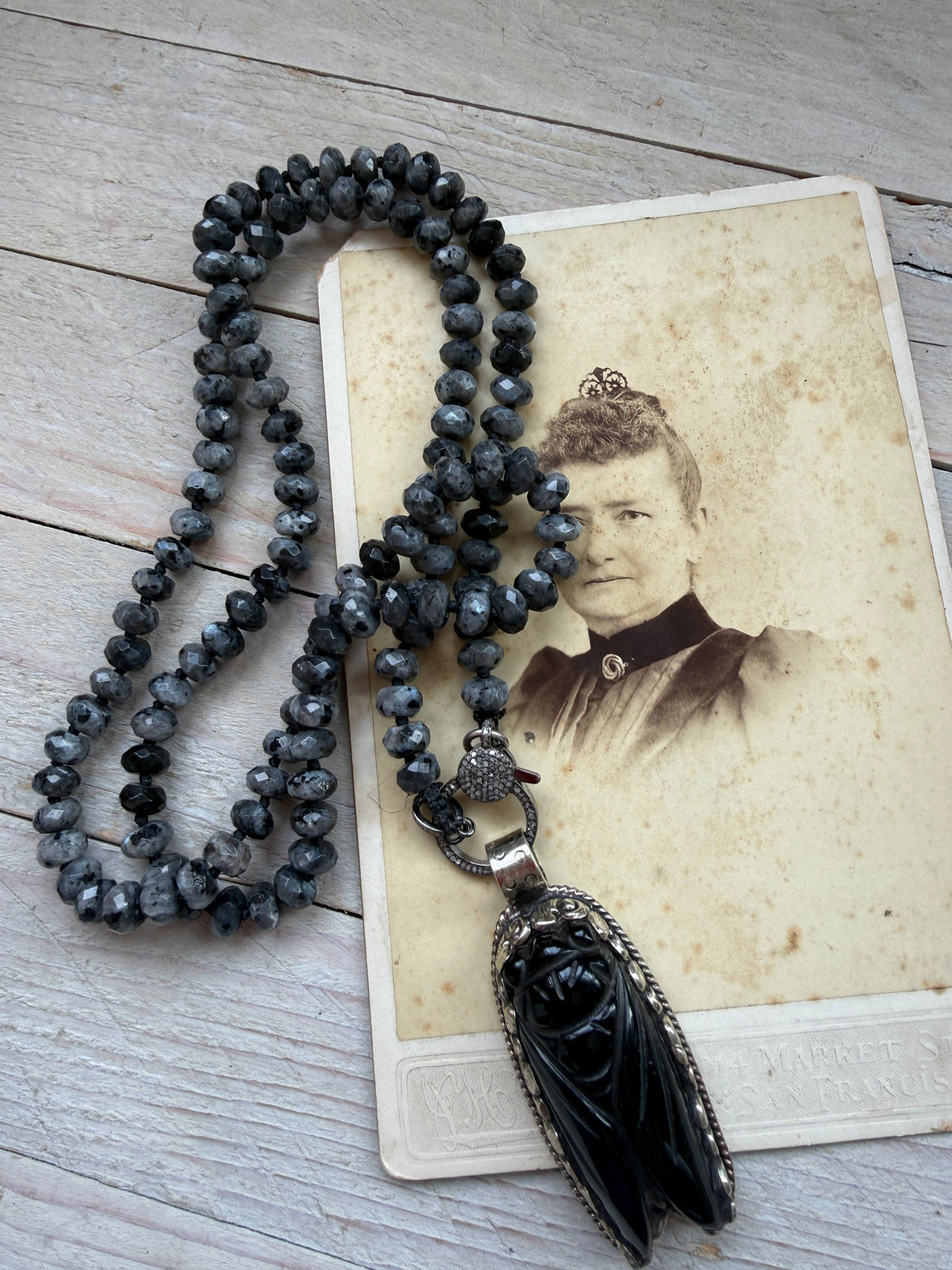 Tibetan Onyx cicada with diamond charm holder/clasp on knotted Norwegian moonstone necklace.