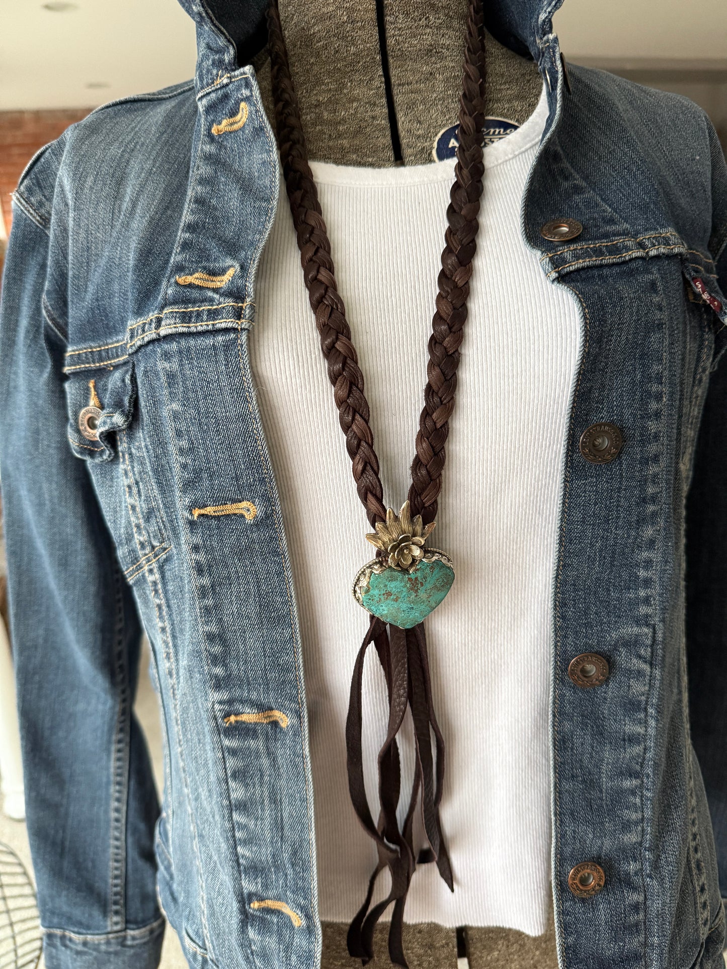 Tibetan turquoise heart on braided deerskin leather necklace. 32”.