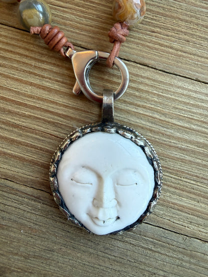 Crazy lace agates knotted on leather necklace with full moon pendant.