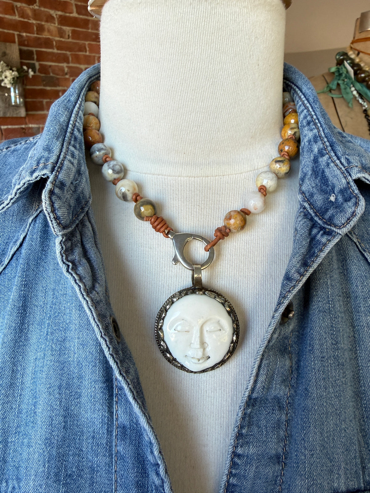 Crazy lace agates knotted on leather necklace with full moon pendant.
