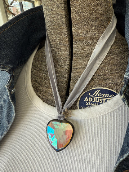 Prism heart on pale blue silk ribbon with fine silver flower charms. 36”.