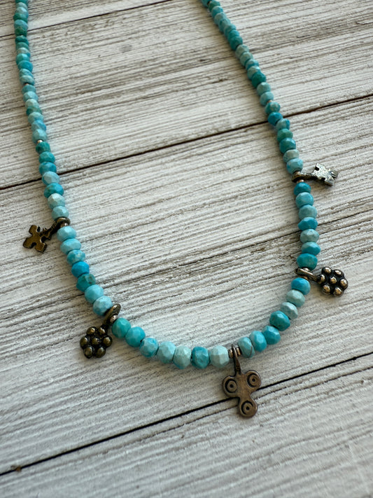 Tiny sterling charms nestled among blue turquoise and fine silver spacers necklace.