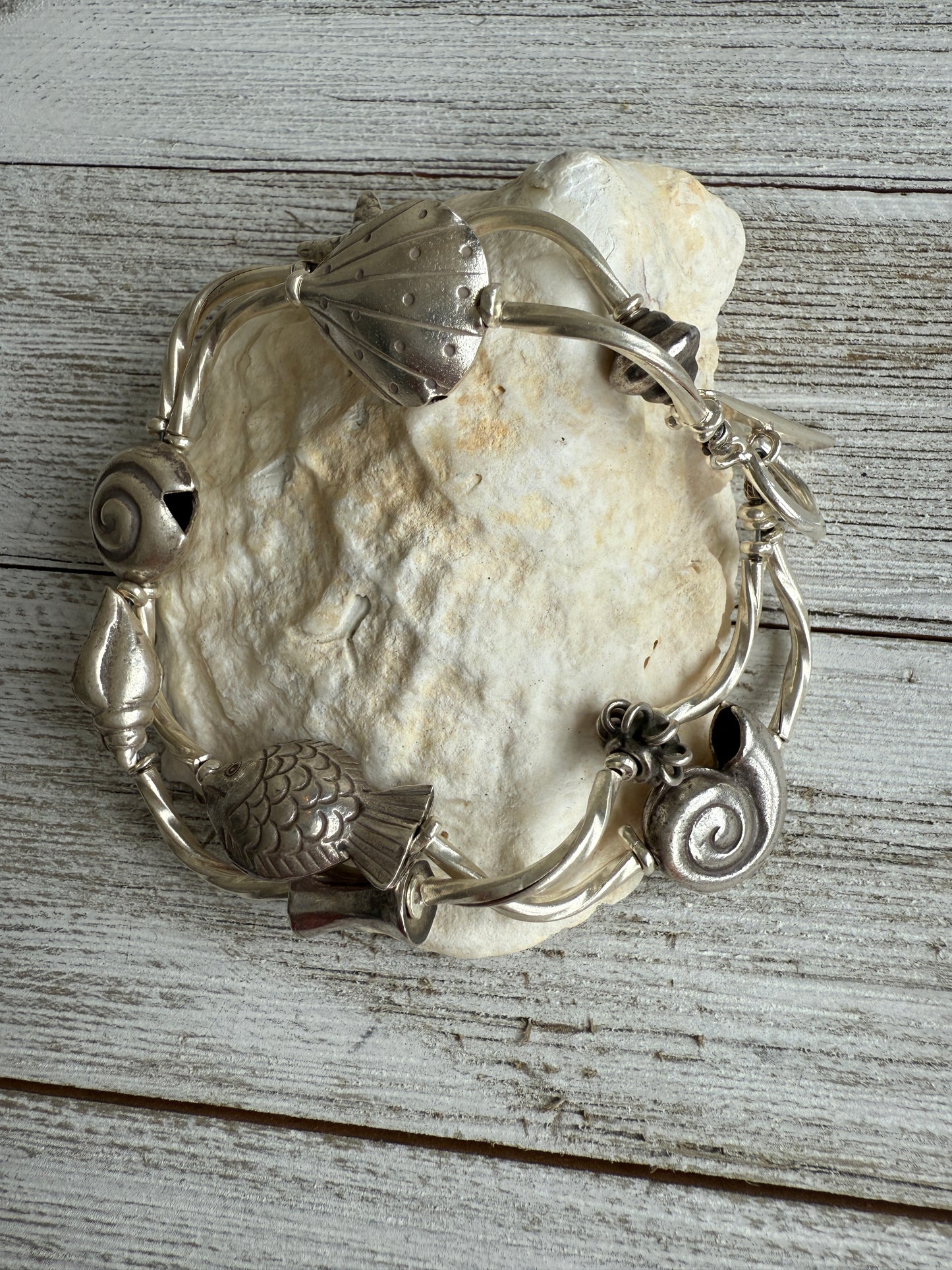 Fine silver sealife and shell bracelet with toggle clasp. 7”.