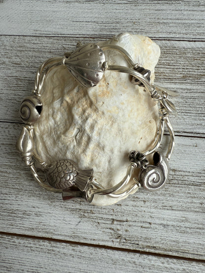 Fine silver sealife and shell bracelet with toggle clasp. 7”.