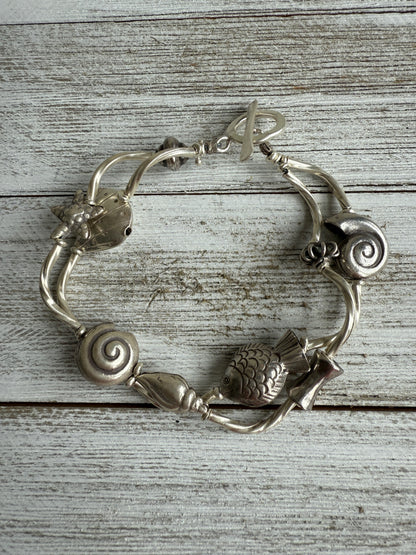 Fine silver sealife and shell bracelet with toggle clasp. 7”.