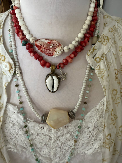 Tibetan cowrie shell pendant on coral necklace. 17.5-18.5”