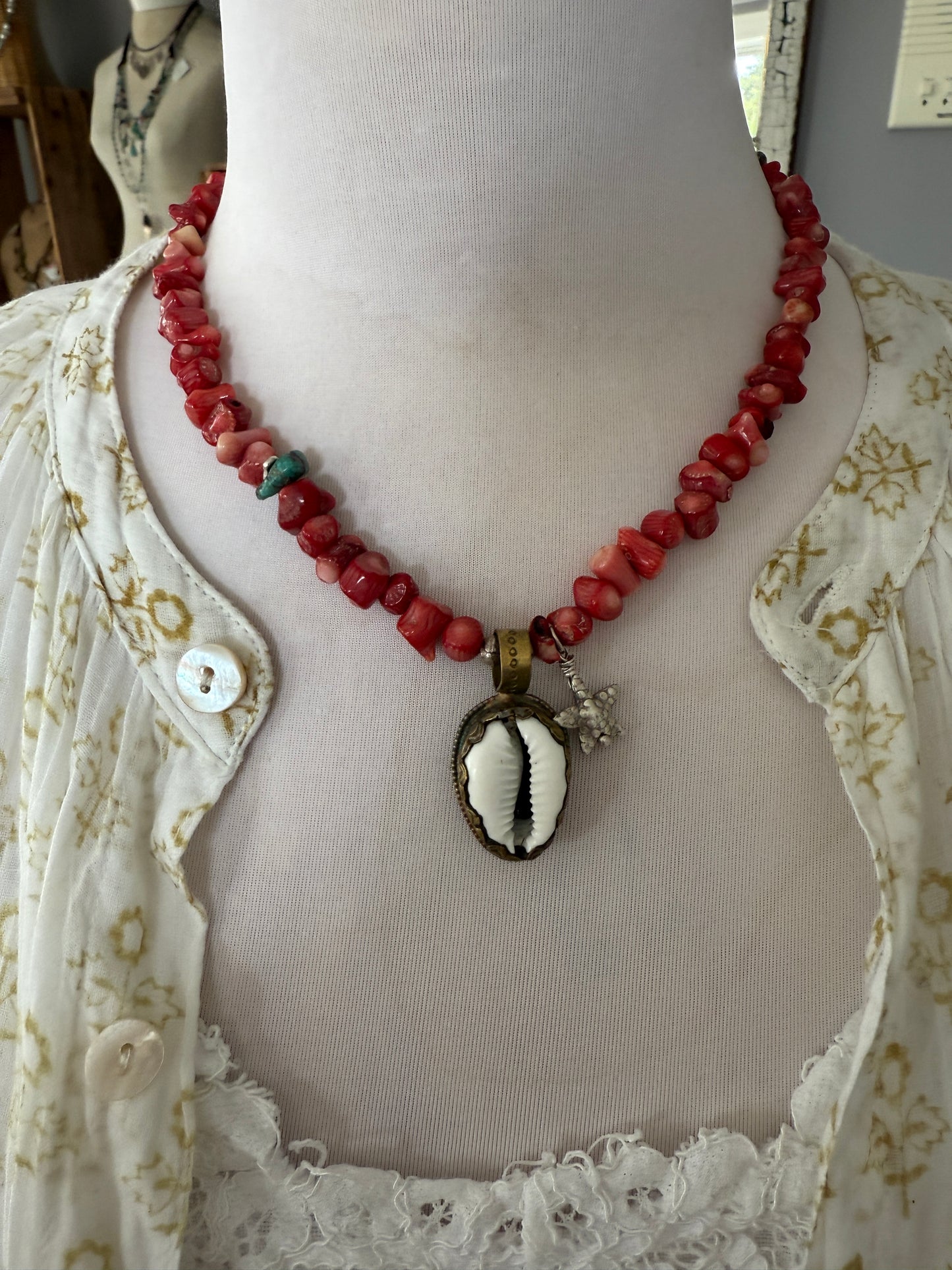 Tibetan cowrie shell pendant on coral necklace. 17.5-18.5”
