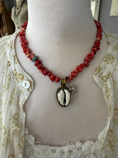 Tibetan cowrie shell pendant on coral necklace. 17.5-18.5”