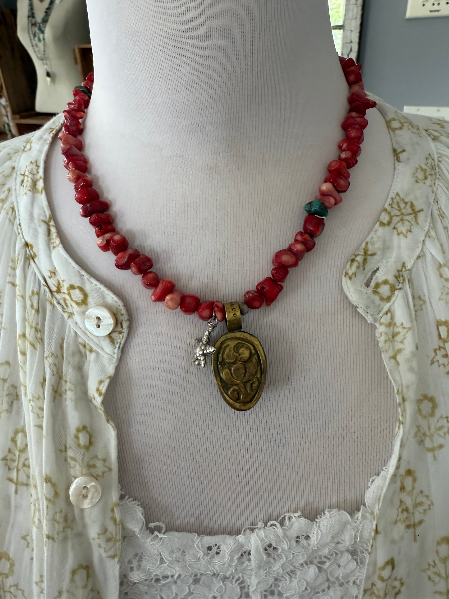 Tibetan cowrie shell pendant on coral necklace. 17.5-18.5”