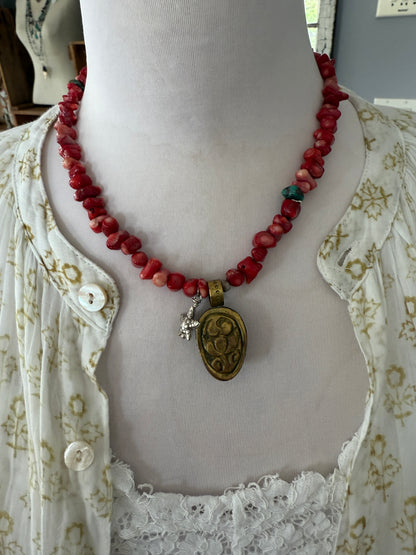 Tibetan cowrie shell pendant on coral necklace. 17.5-18.5”