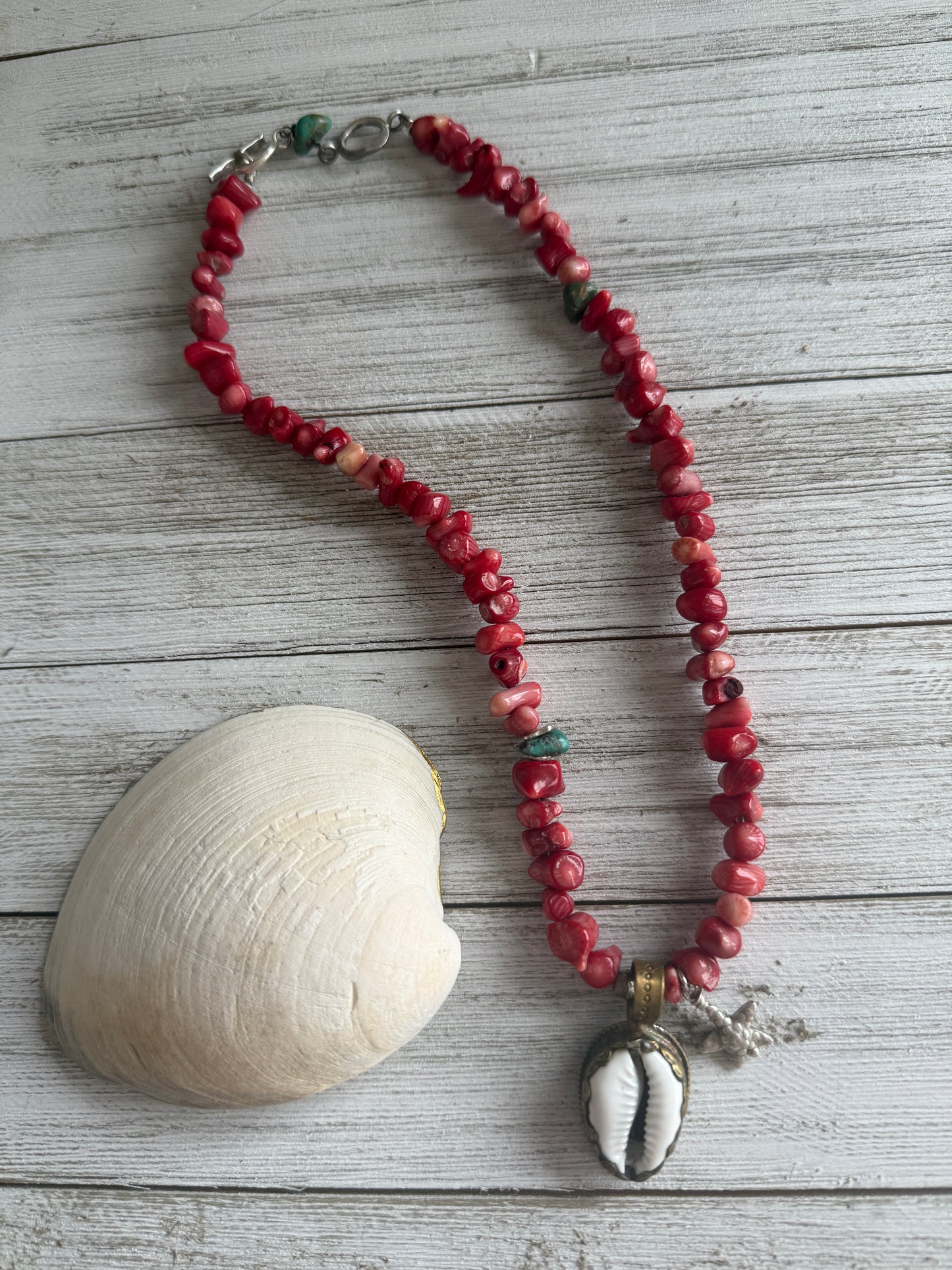 Tibetan cowrie shell pendant on coral necklace. 17.5-18.5”
