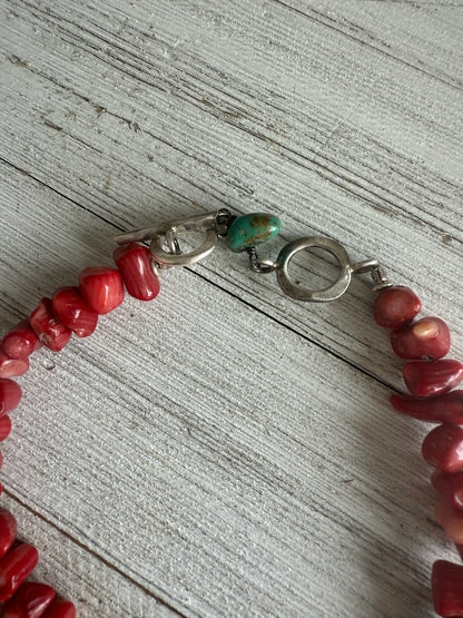 Tibetan cowrie shell pendant on coral necklace. 17.5-18.5”