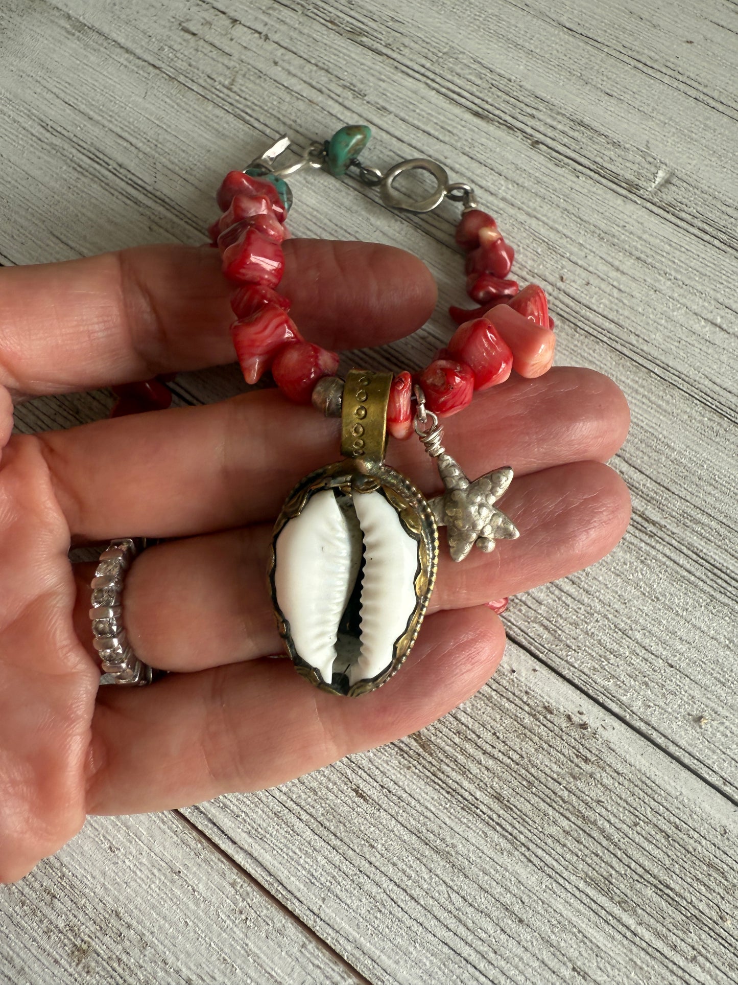 Tibetan cowrie shell pendant on coral necklace. 17.5-18.5”
