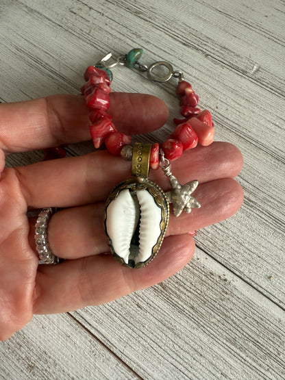 Tibetan cowrie shell pendant on coral necklace. 17.5-18.5”