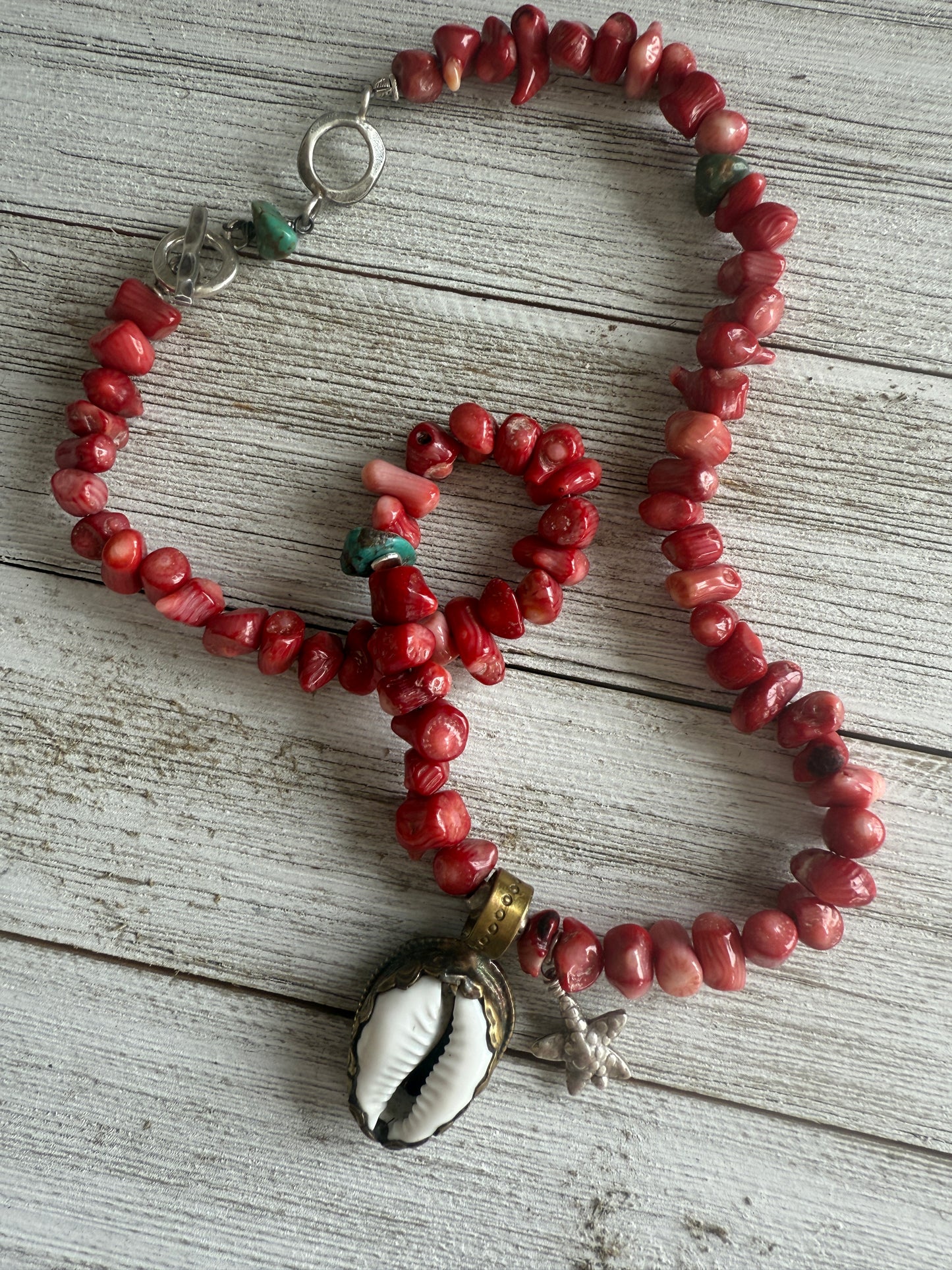 Tibetan cowrie shell pendant on coral necklace. 17.5-18.5”