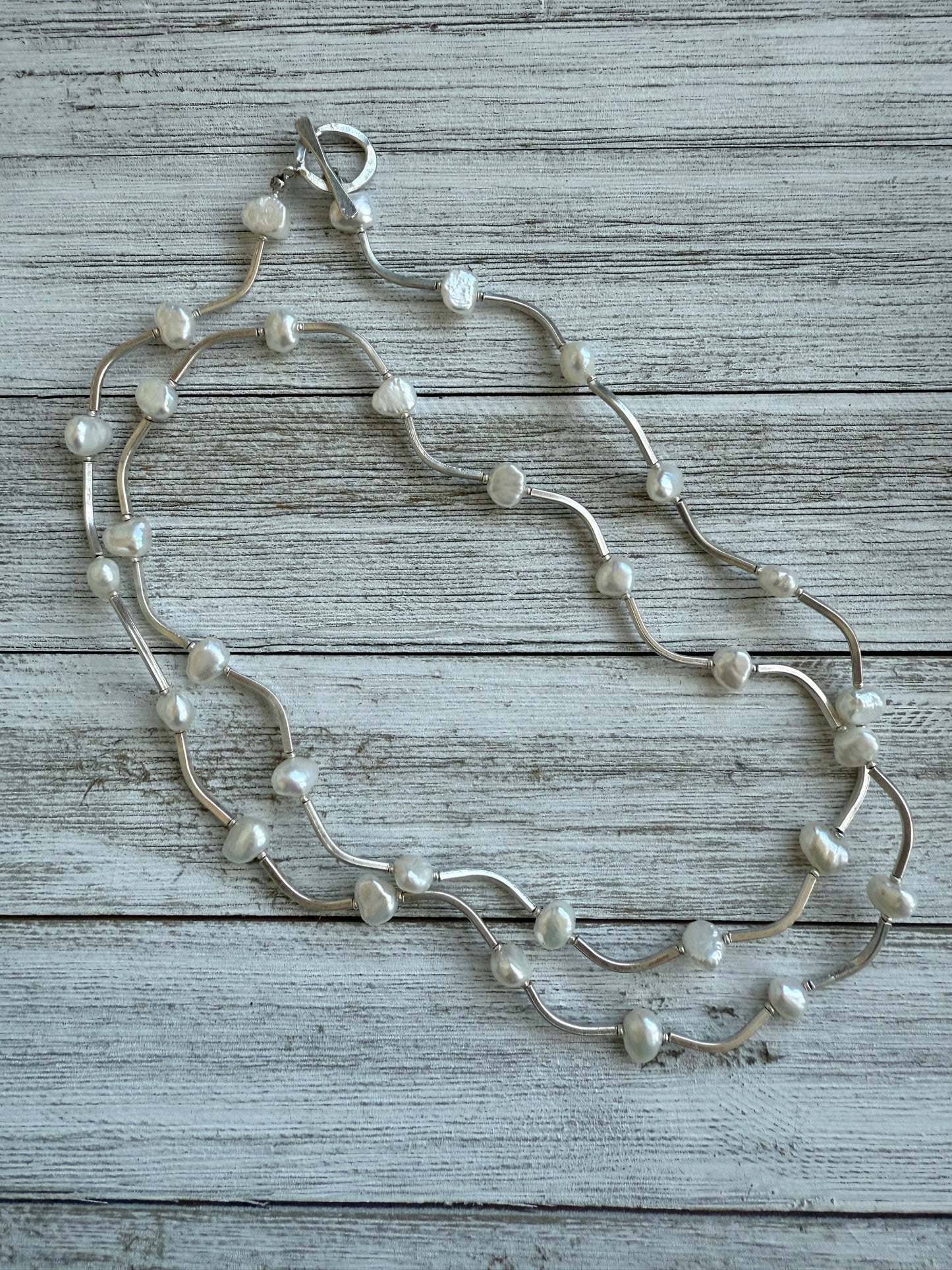 Long fine silver and pearl necklace. 35.75”