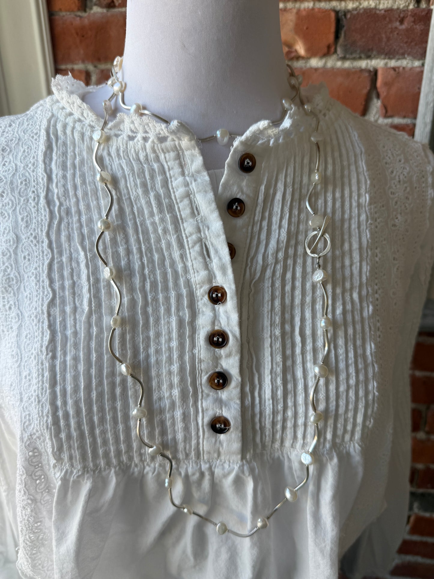 Long fine silver and pearl necklace. 35.75”