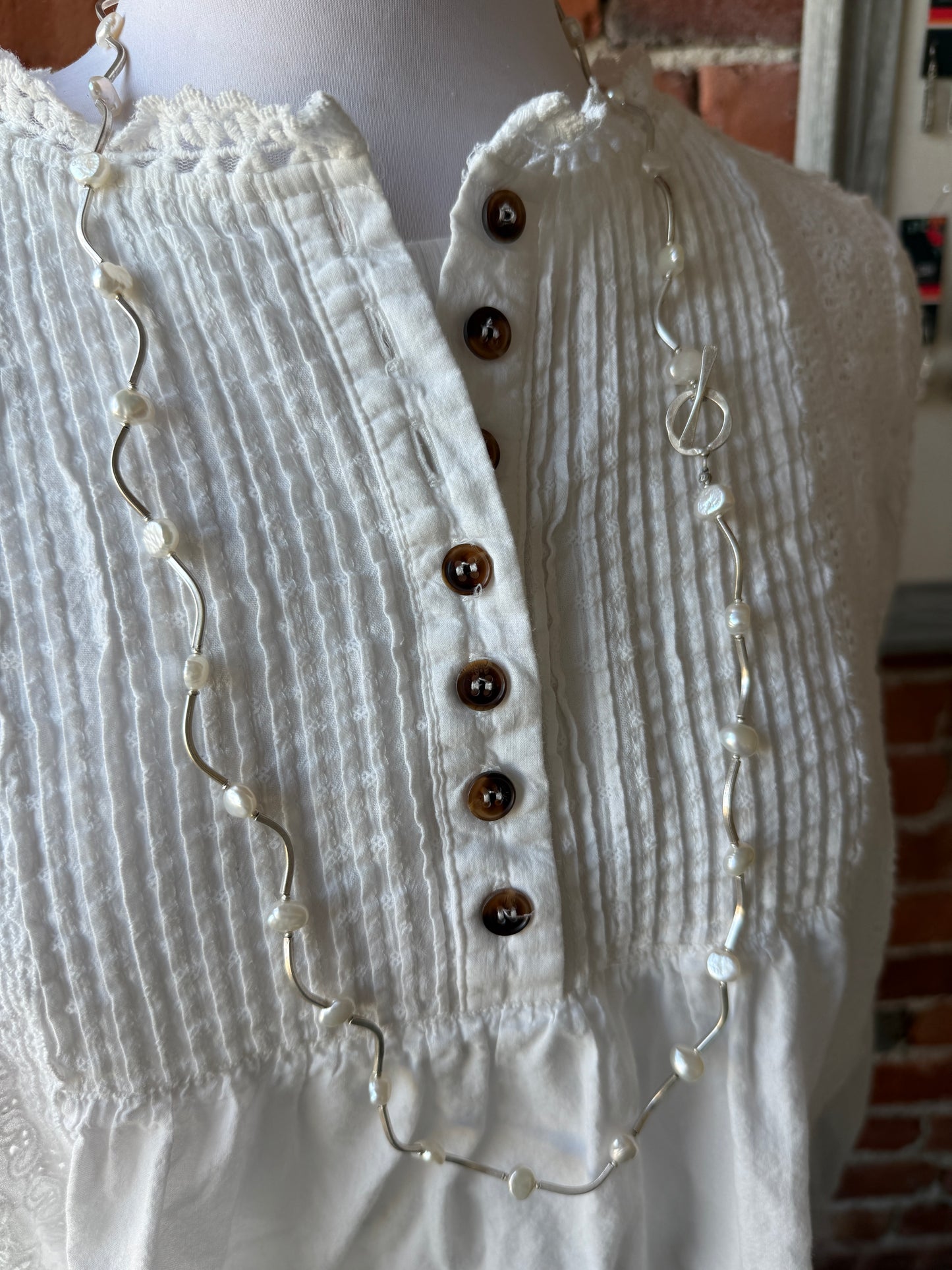 Long fine silver and pearl necklace. 35.75”