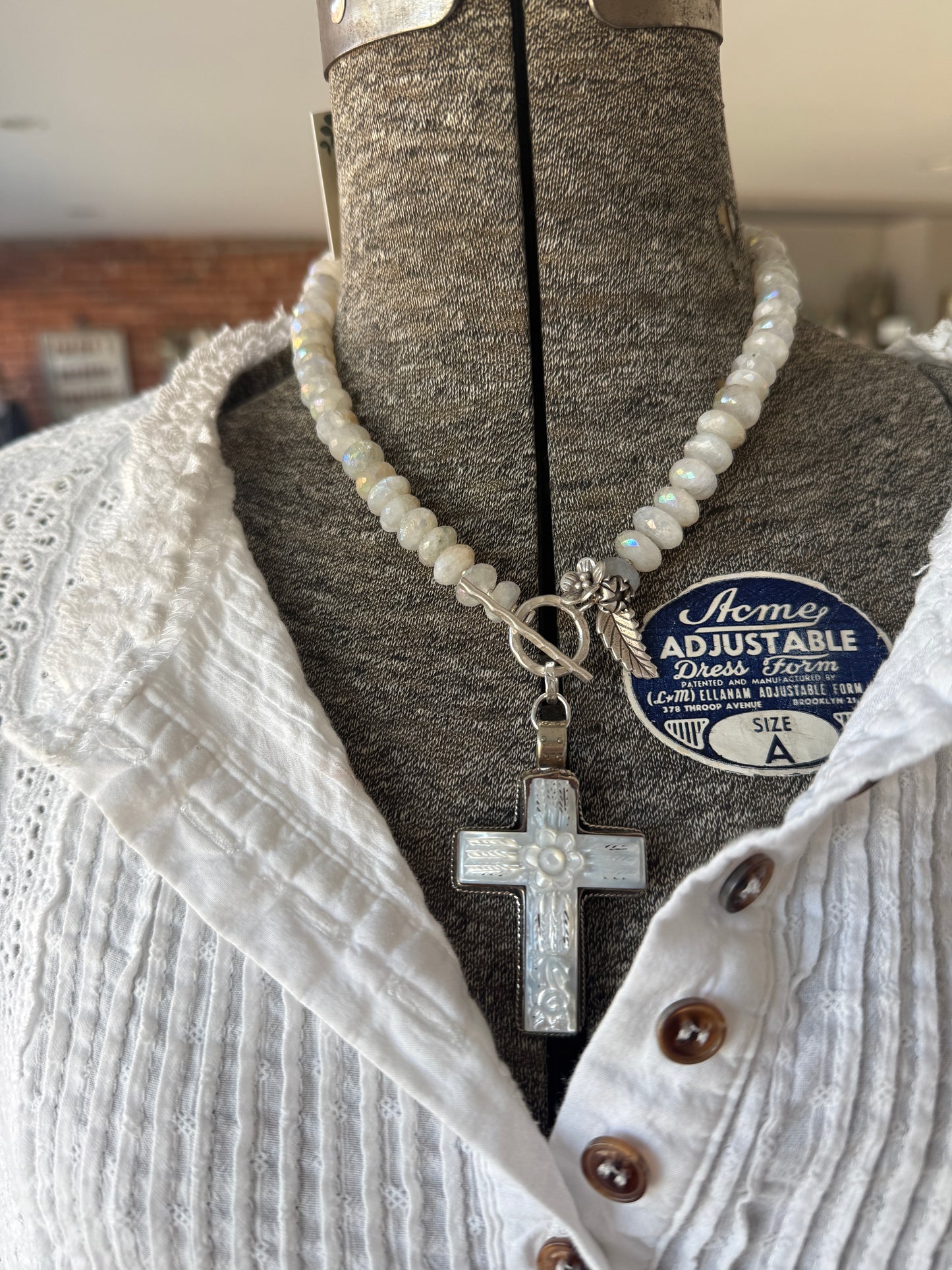 Mother of pearl carved cross on faceted moonstone short necklace. 18”