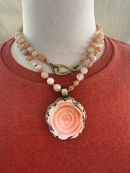 Hand carved pink Opal Tibetan rose pendant hand knotted onto cherry blossom agates necklace. 34” long.
