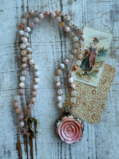 Hand carved pink Opal Tibetan rose pendant hand knotted onto cherry blossom agates necklace. 34” long.