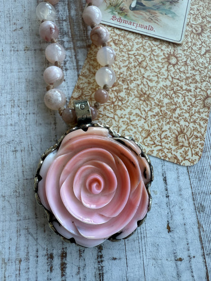 Hand carved pink Opal Tibetan rose pendant hand knotted onto cherry blossom agates necklace. 34” long.