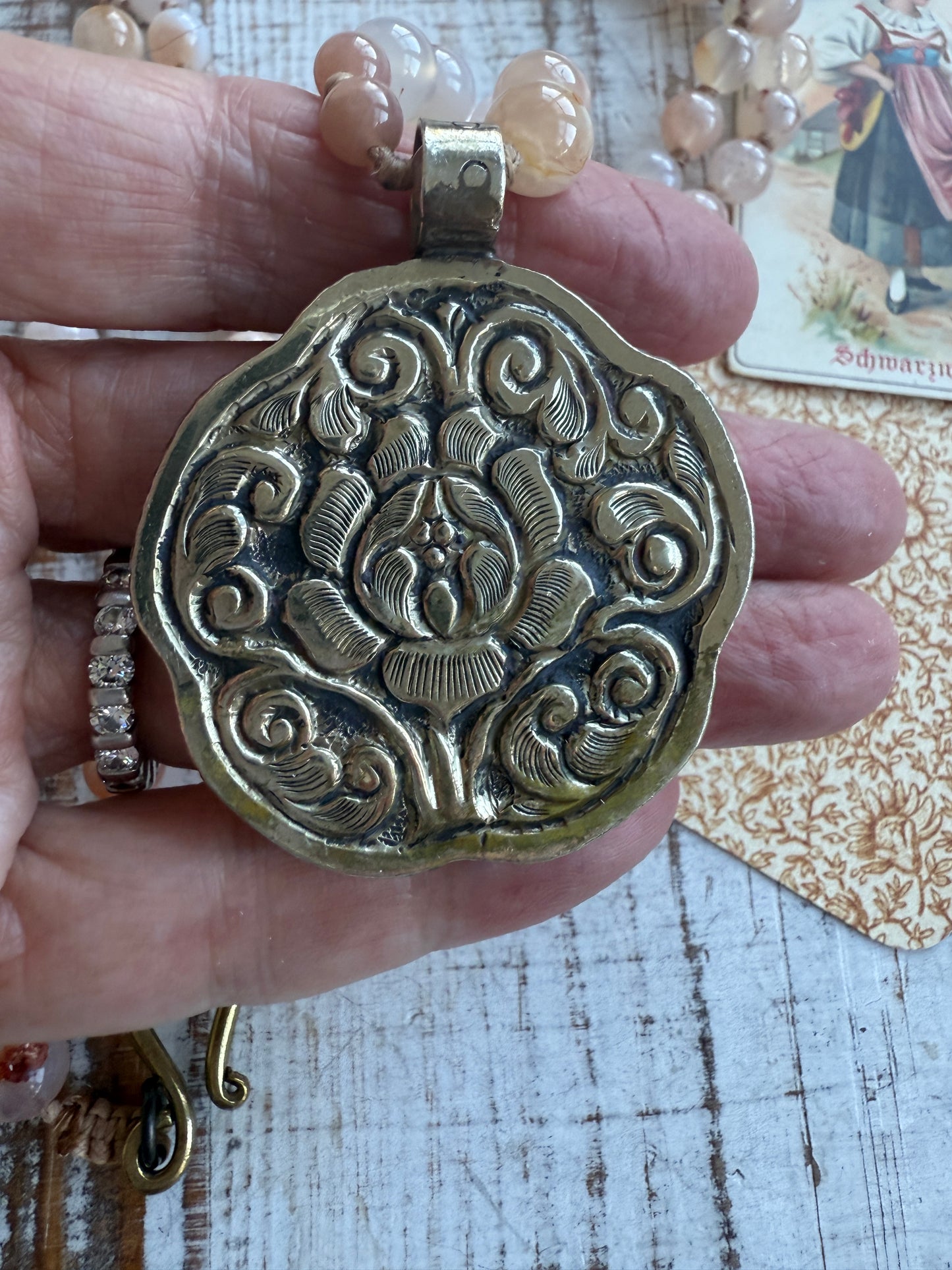 Hand carved pink Opal Tibetan rose pendant hand knotted onto cherry blossom agates necklace. 34” long.