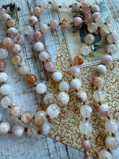 Hand carved pink Opal Tibetan rose pendant hand knotted onto cherry blossom agates necklace. 34” long.