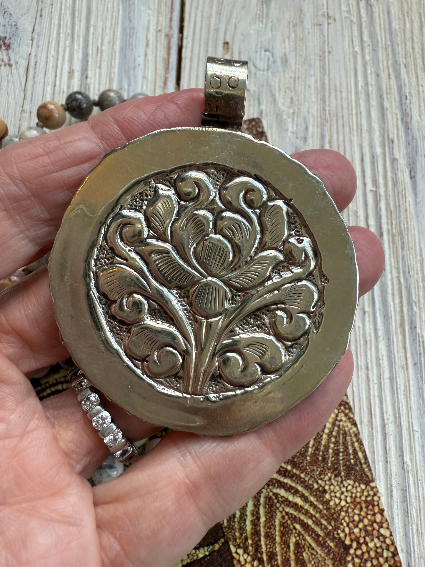 Tibetan carved bone dahlia on knotted fossilized coral long necklace.