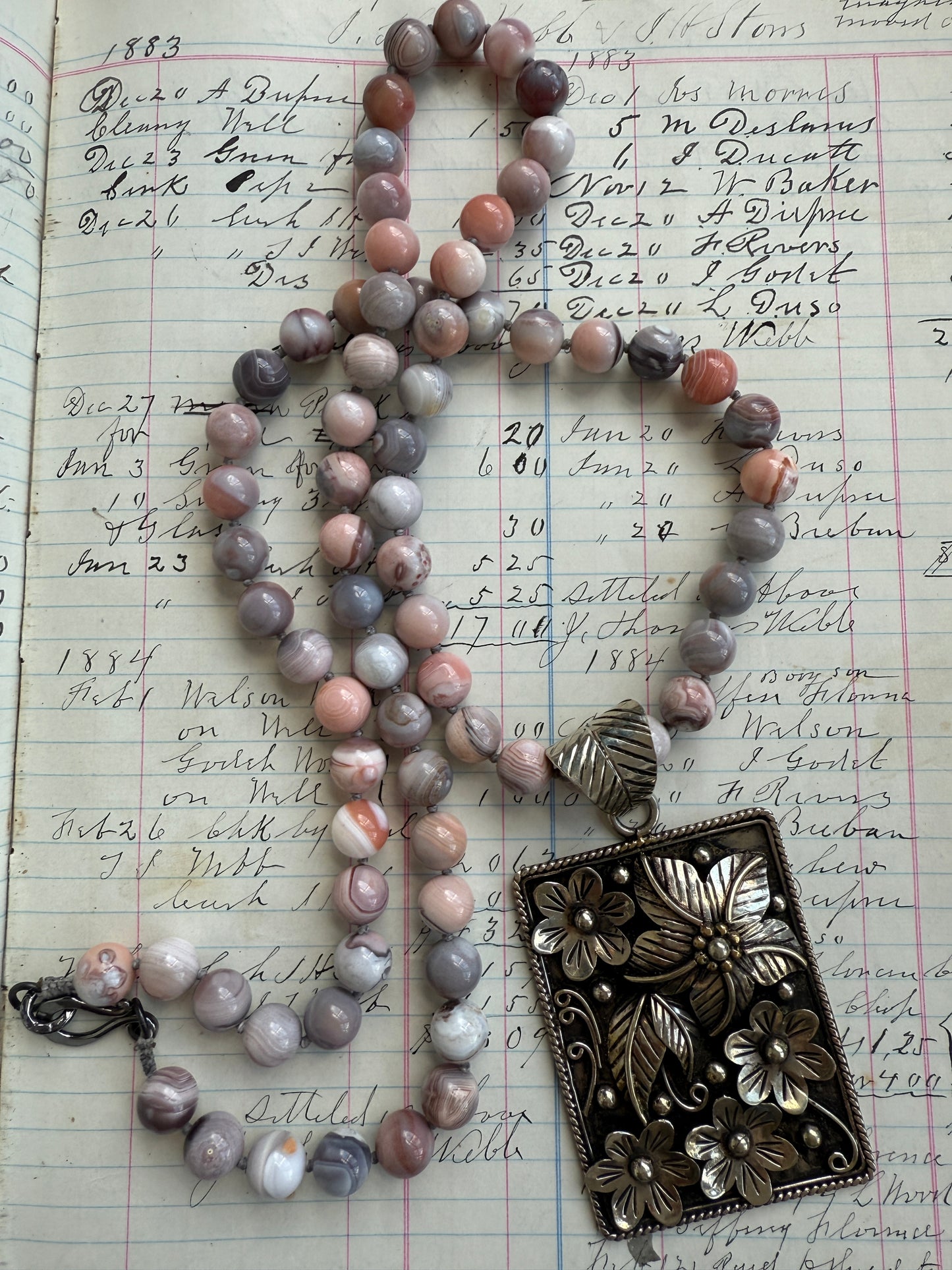 Hand knotted Botswana agates on silver flower pendant statement necklace.