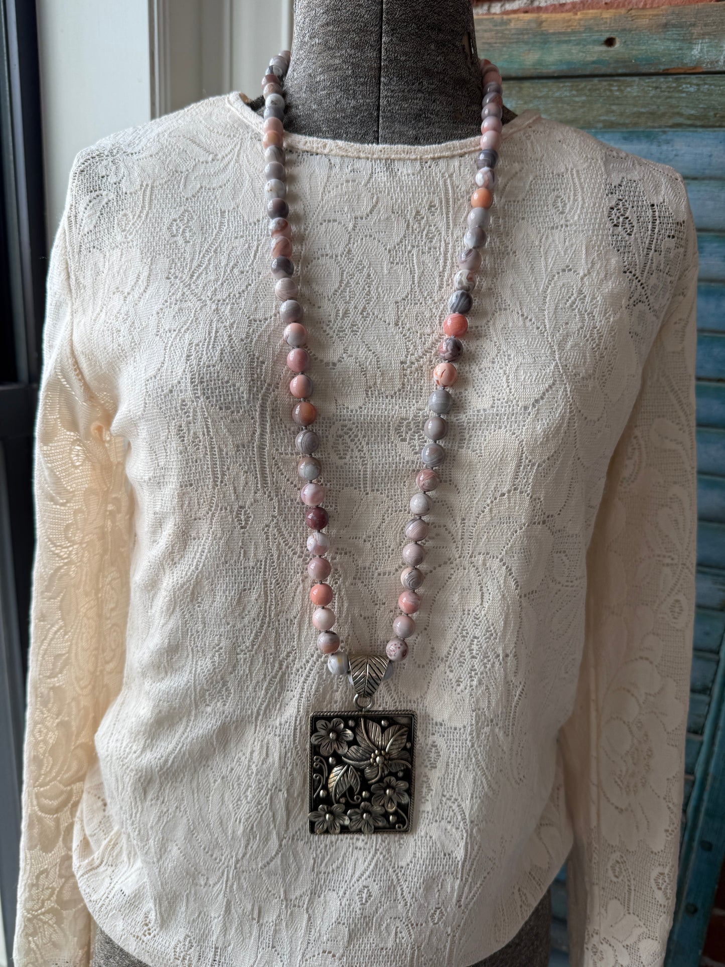 Hand knotted Botswana agates on silver flower pendant statement necklace.