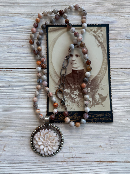 Tibetan carved bone dahlia on knotted fossilized coral long necklace.