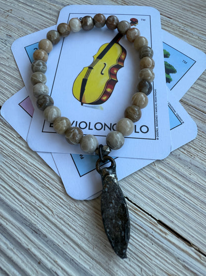 Smoky quartz druzie hangs from a stack bracelet of fossil coral beads 6.5-7”.