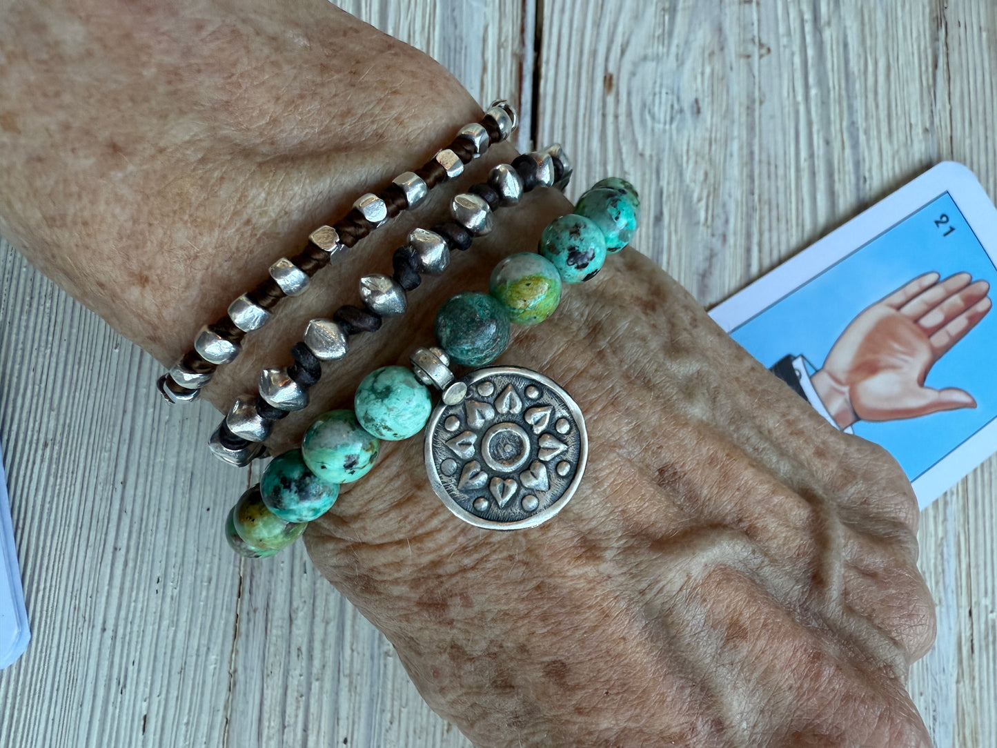 Turquoise beads with a vintage sterling bead and charm stretch bracelet. 6.5-7”