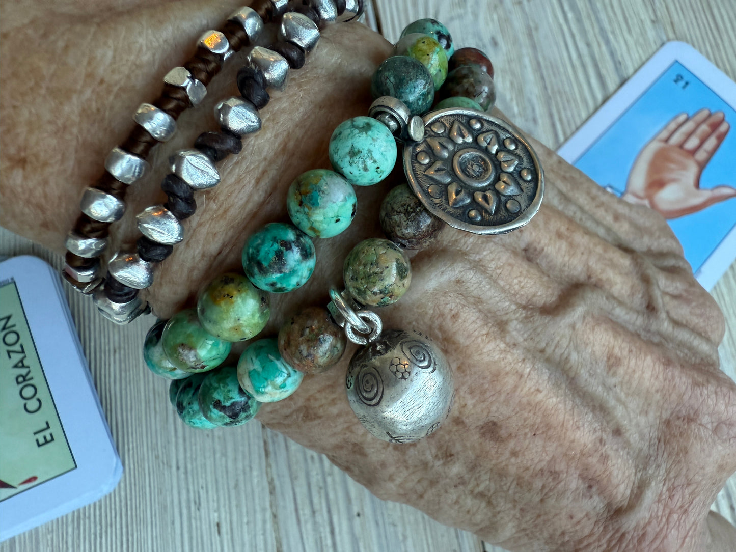 Turquoise beads with a vintage sterling bead and charm stretch bracelet. 6.5-7”