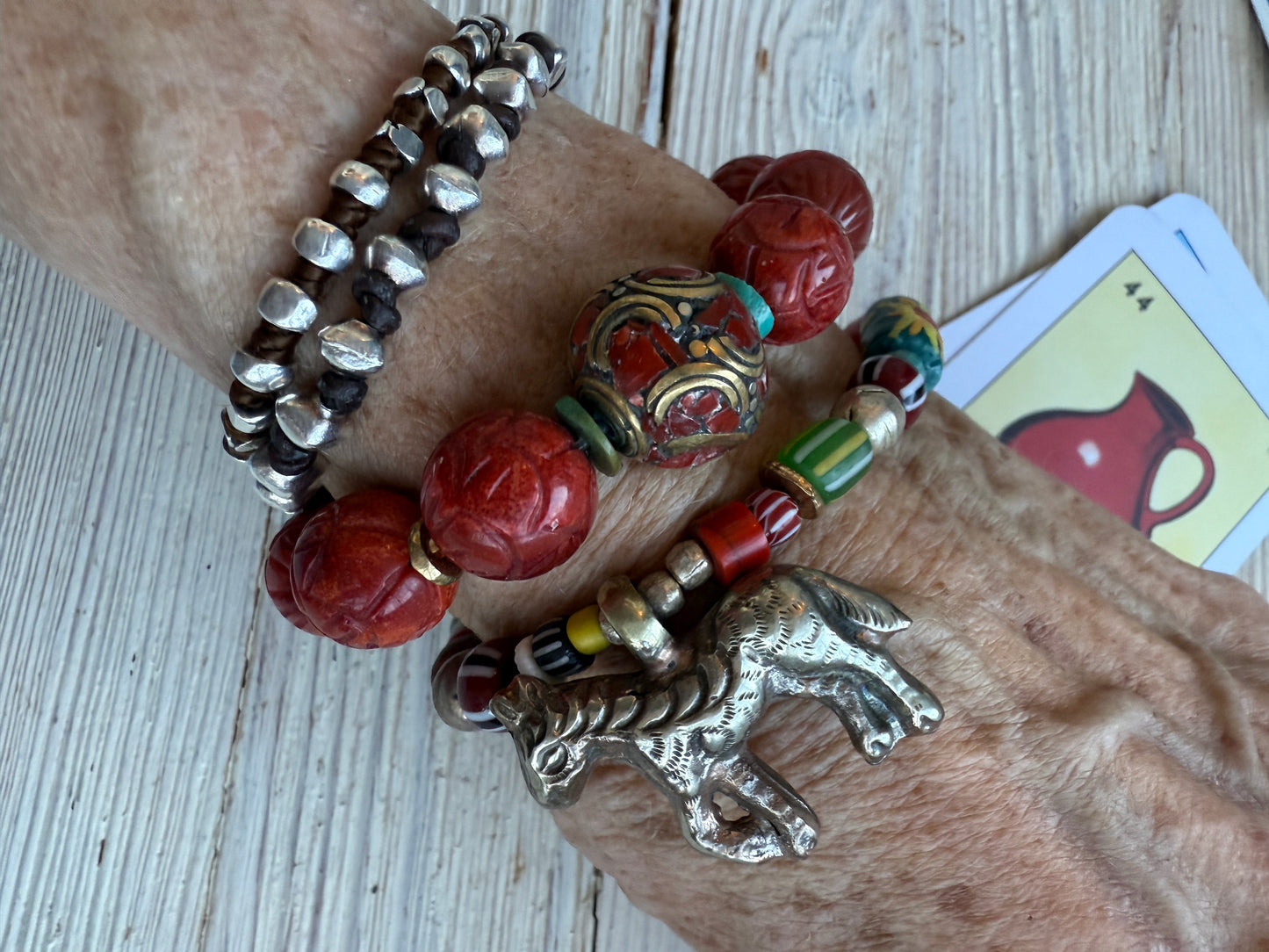 Donkey charm on a mix of gems, trade beads, and Ethiopian silver stretch bracelet. 6.5”