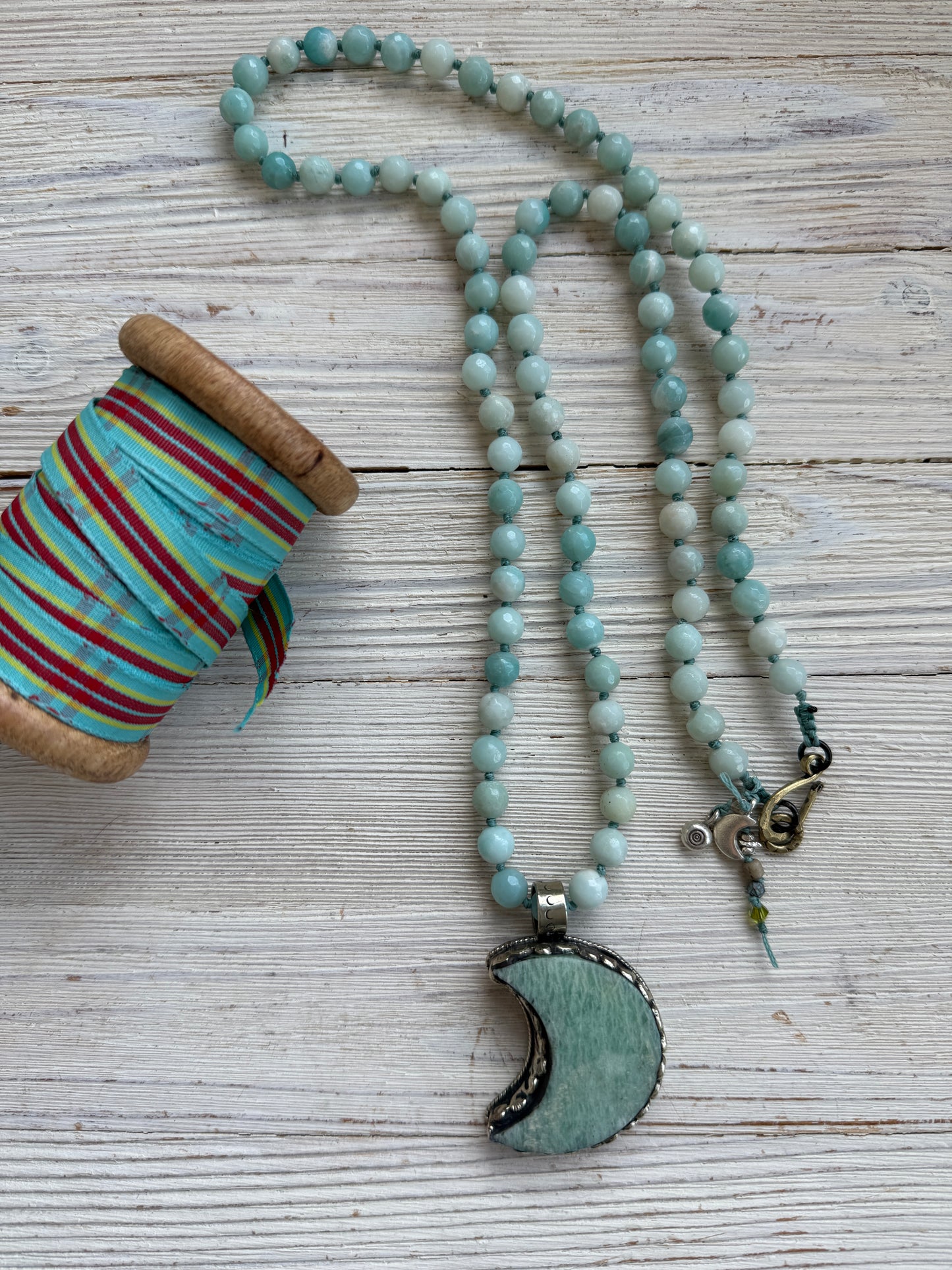 Tibetan amazonite crescent moon on knotted amazonite beads. 34”